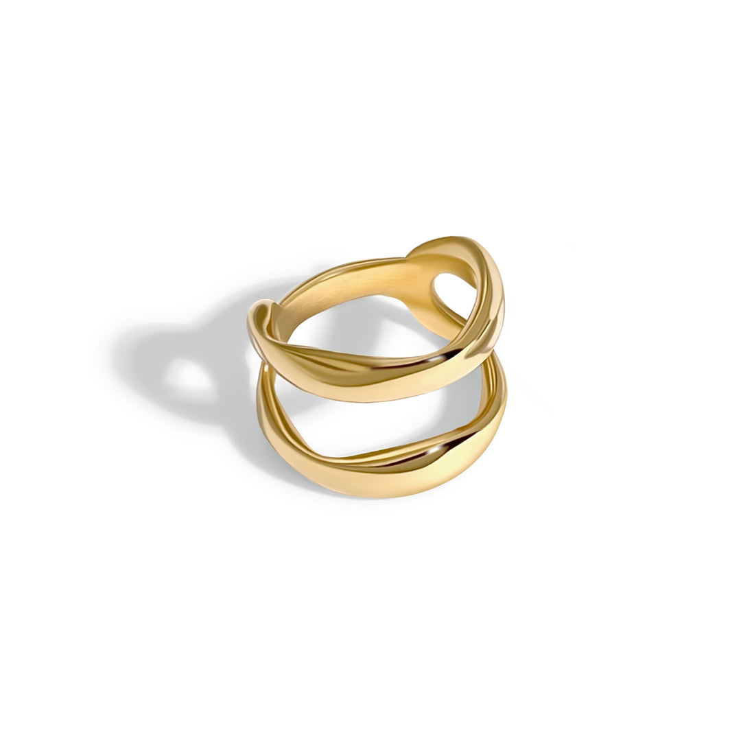 Gold chunky twisted ring with curved interlocking bands on white background