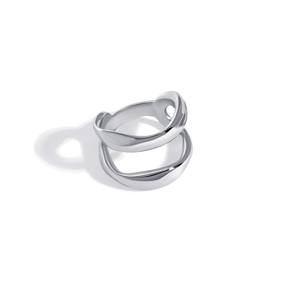Silver double band ring with curved interlocking design photographed against white background