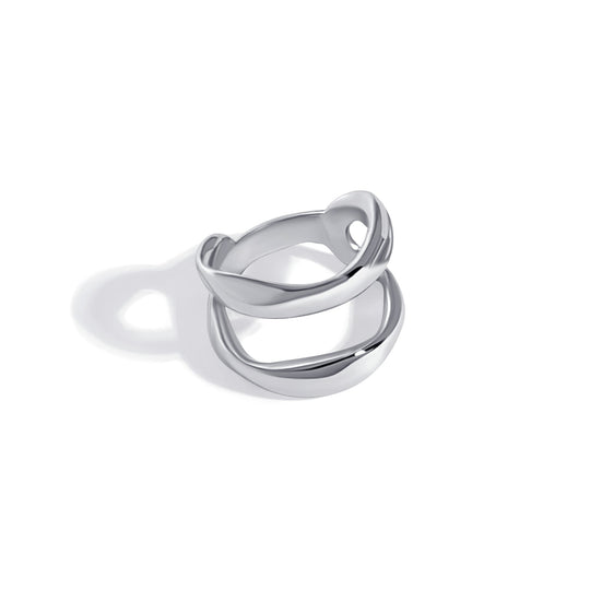 Silver double band ring with curved interlocking design photographed against white background
