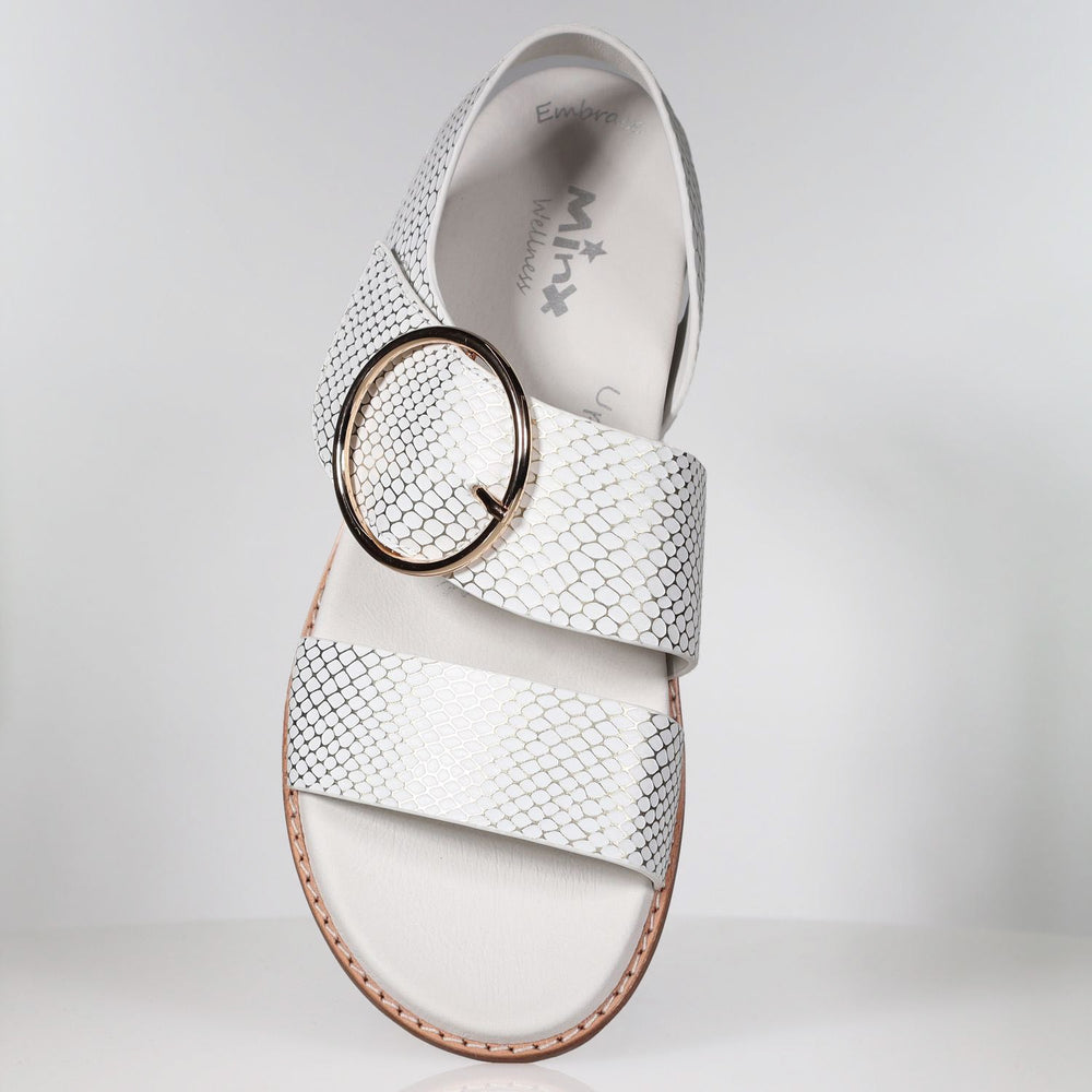 White leather sandal with gold snake embossed pattern and circular buckle detail