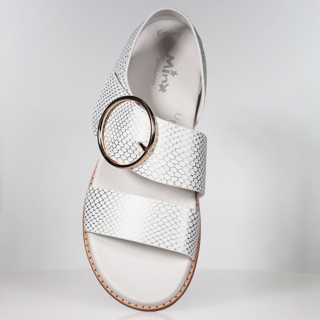 White leather sandal with gold snake embossed pattern and circular buckle detail
