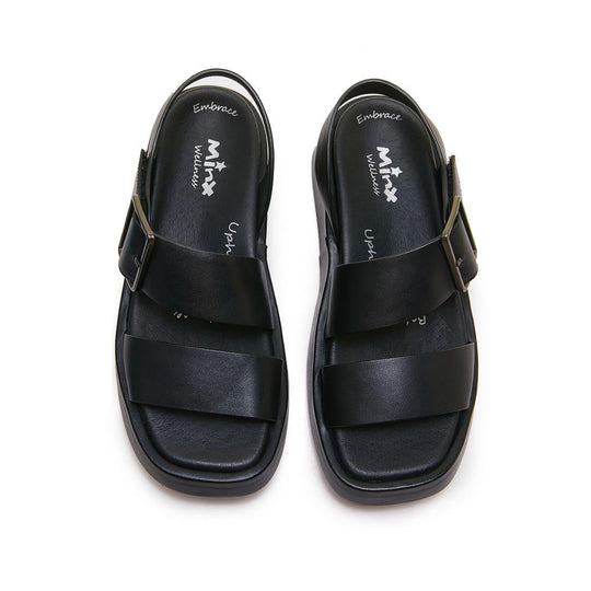 Black leather sandals with velcro straps and heel straps, top-down view