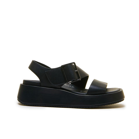 Black platform sandal with velcro ankle strap and single toe strap, side profile view