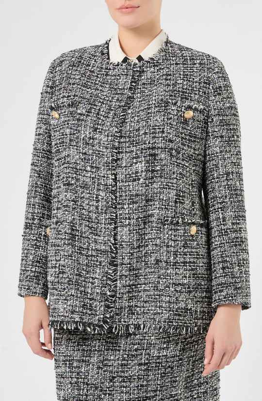 Black and white tweed boucle jacket with fringe trim, gold buttons, and collarless neckline, front view on model