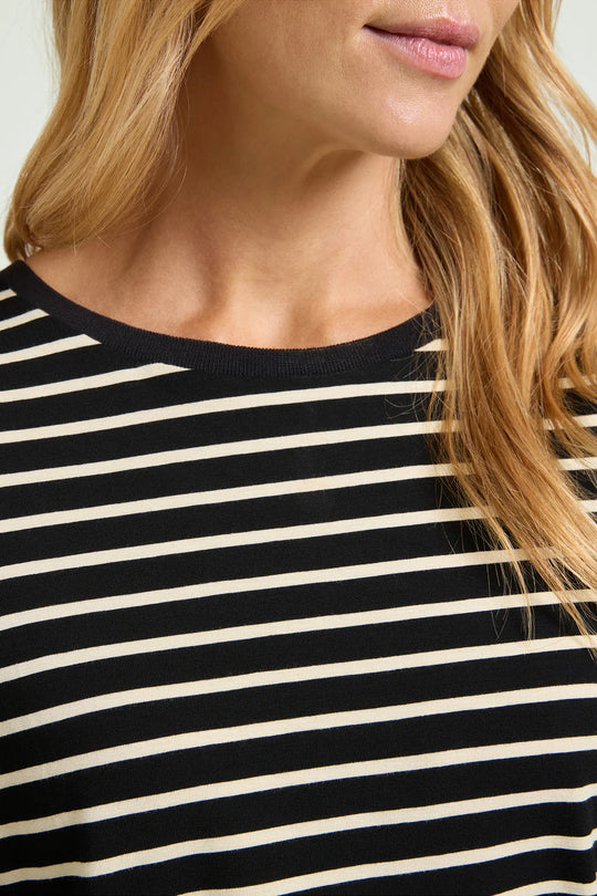 Close-up of black jersey tee with thin milky horizontal stripes and crew neck