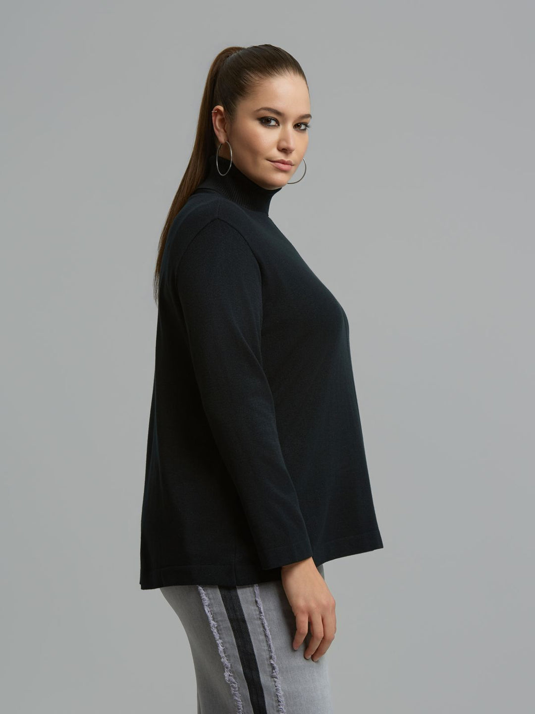 Black turtleneck sweater with long sleeves, side profile