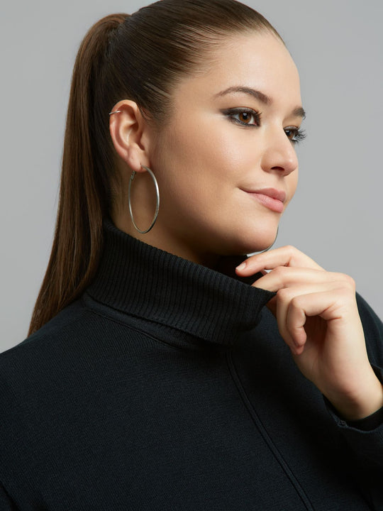Black ribbed turtleneck sweater neckline and collar seam detail