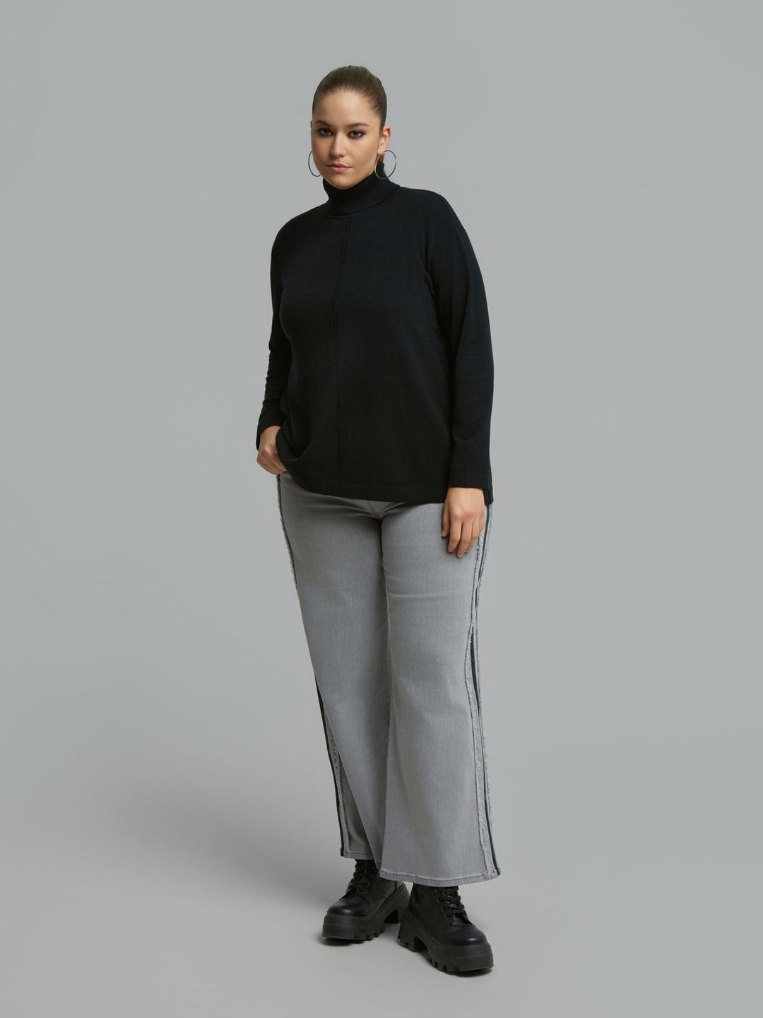 Black turtleneck sweater with ribbed neck and front seam, loose long sleeves