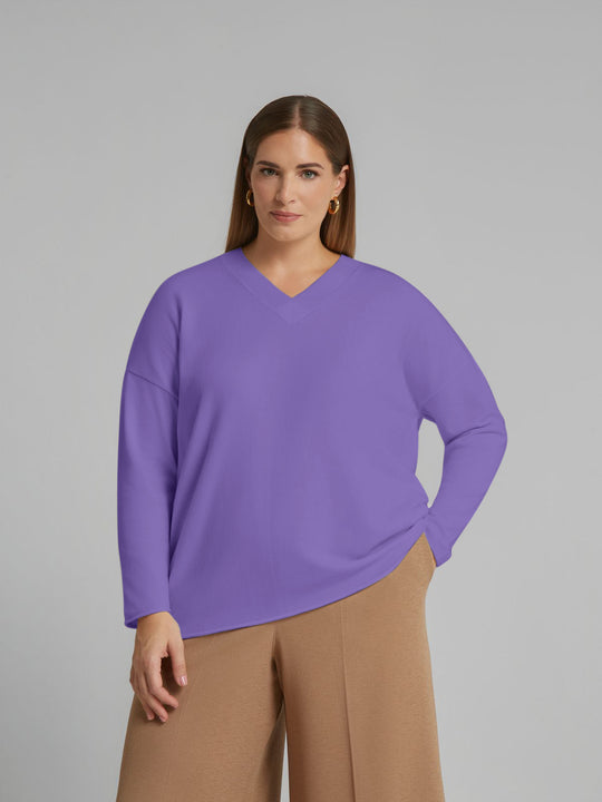 Lilac V-neck knit sweater with long sleeves and draped, relaxed silhouette.