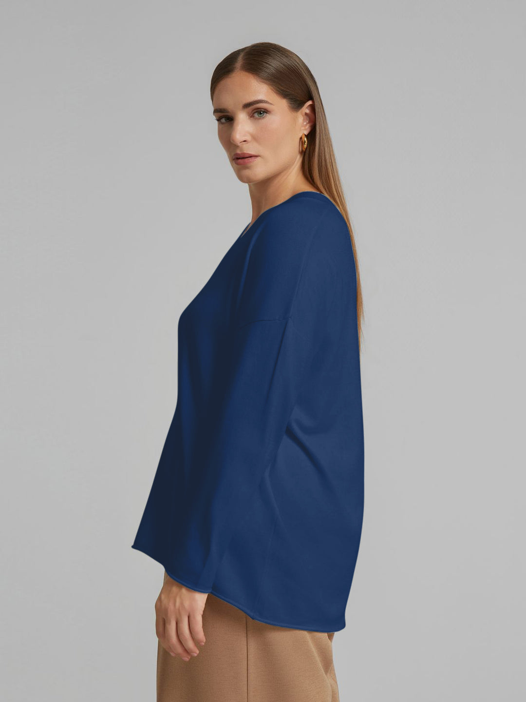 Indigo V-neck sweater with long sleeve and side profile drape