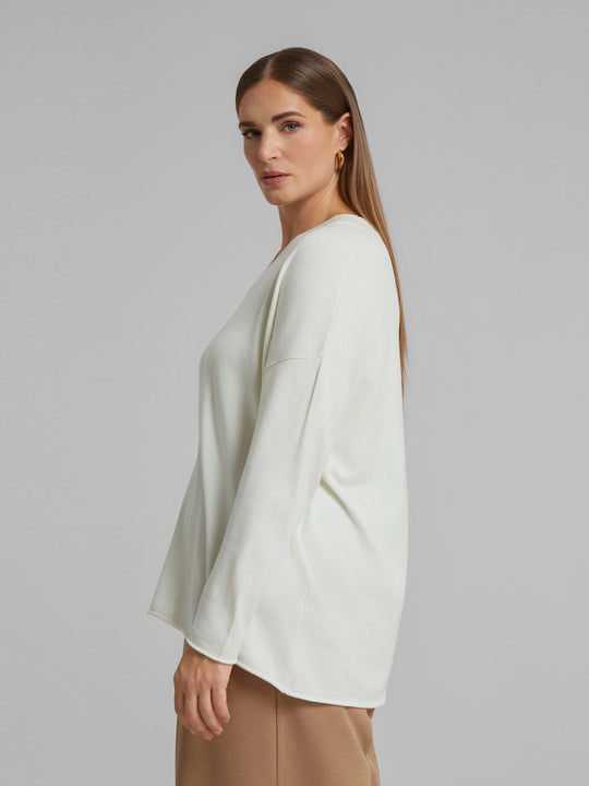 Off white V-neck sweater with long sleeves and relaxed shoulder seam