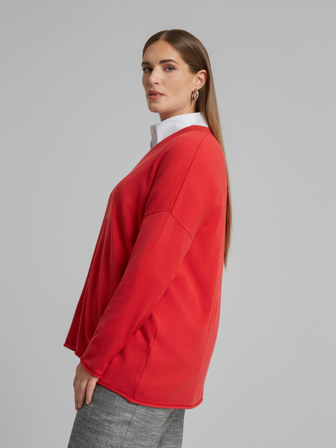 Red V-neck sweater with long sleeves, side profile