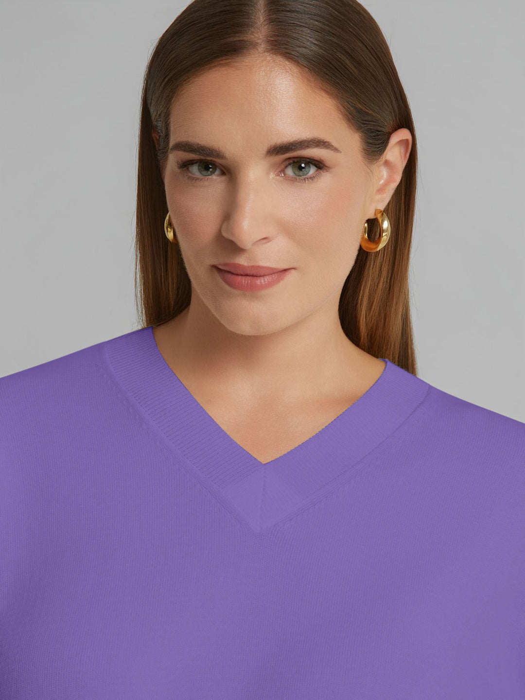 Lilac V-neck knit sweater close-up showing neckline and smooth knit texture.