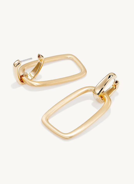 Pair of gold rectangular drop hoop earrings with brushed matte finish and polished connector, angled view