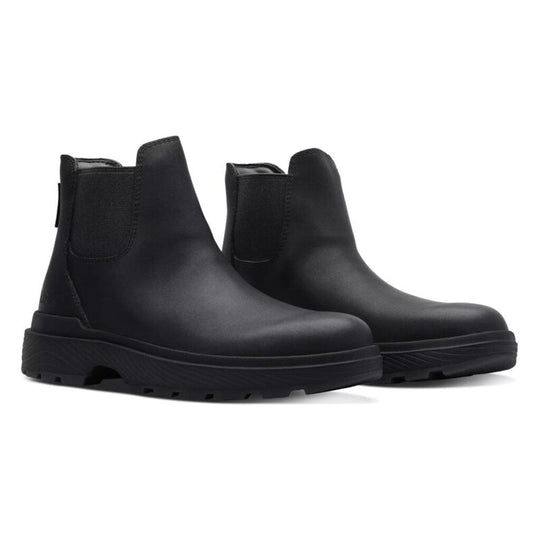 Black Chelsea boots side-by-side showing elastic gore and rugged tread sole