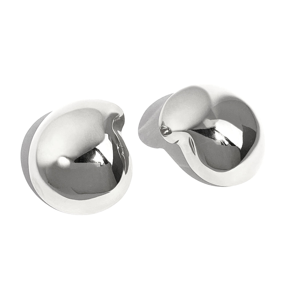 Pair of chunky twisted metal stud earrings with sculptural knot design on white background