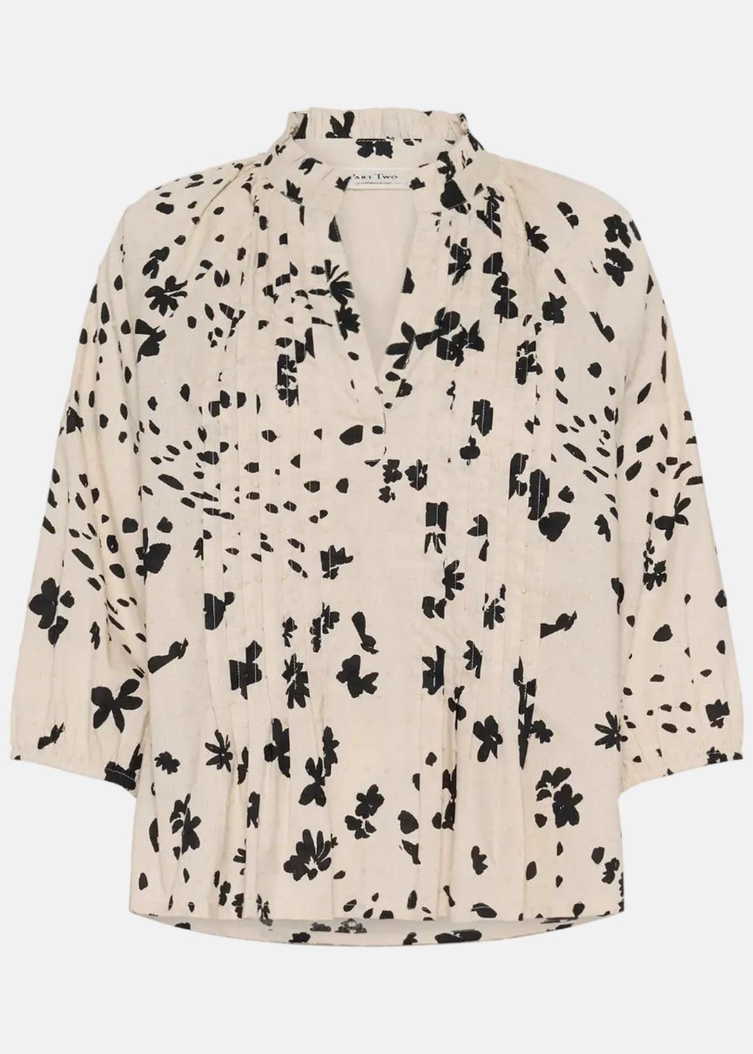 Beige blouse with black floral pattern on a white background