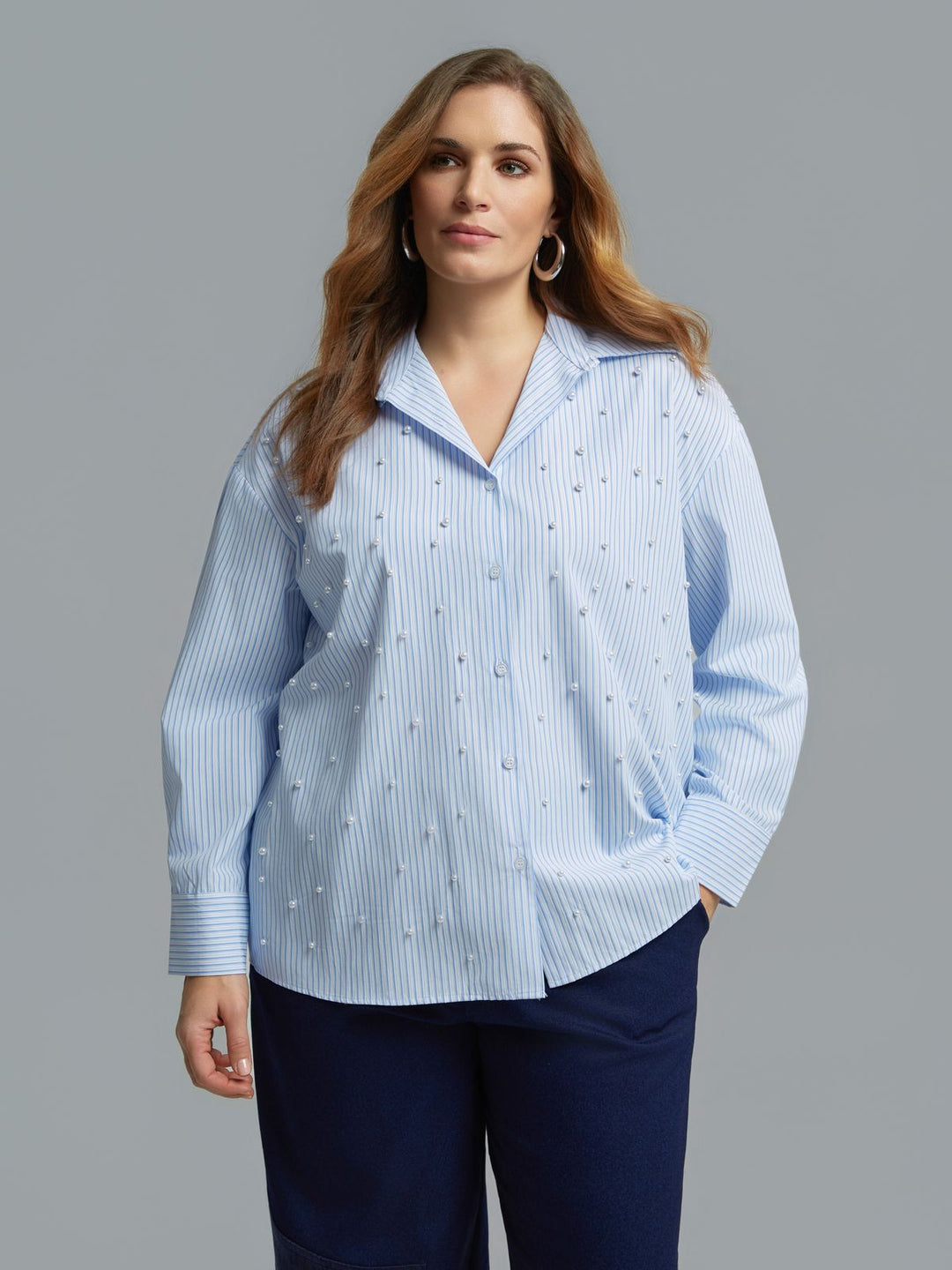 Light blue pinstripe button-front shirt with scattered pearl embellishments, long sleeves, front view on model