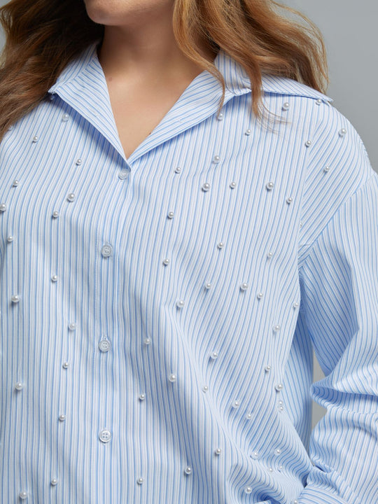 Light blue striped long-sleeve button-front shirt adorned with scattered pearl embellishments, front view on model