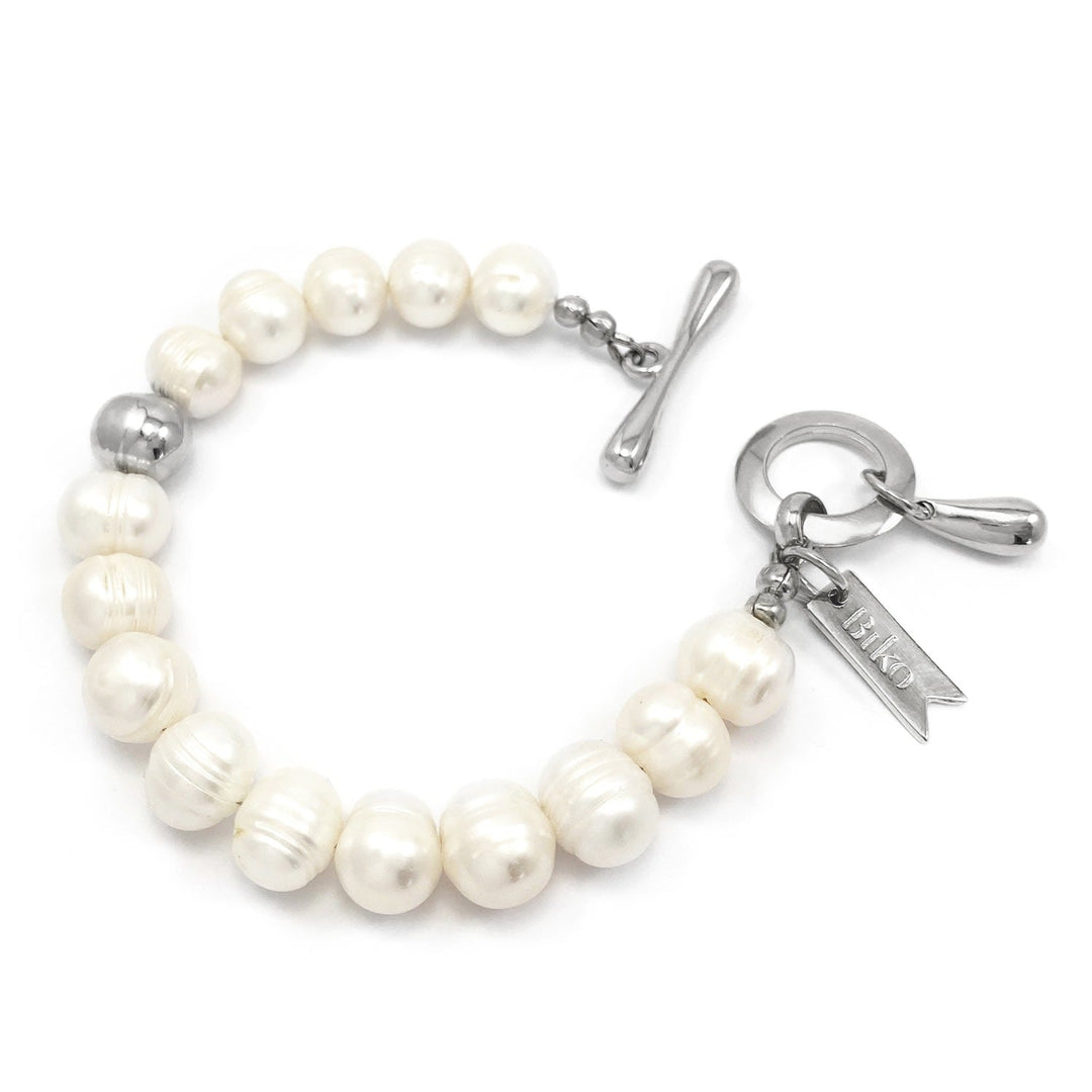 Silver pearl charm bracelet with toggle clasp, bar charm, and star-shaped charm