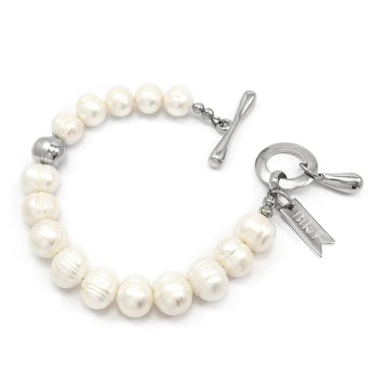 Silver pearl charm bracelet with toggle clasp, bar charm, and star-shaped charm