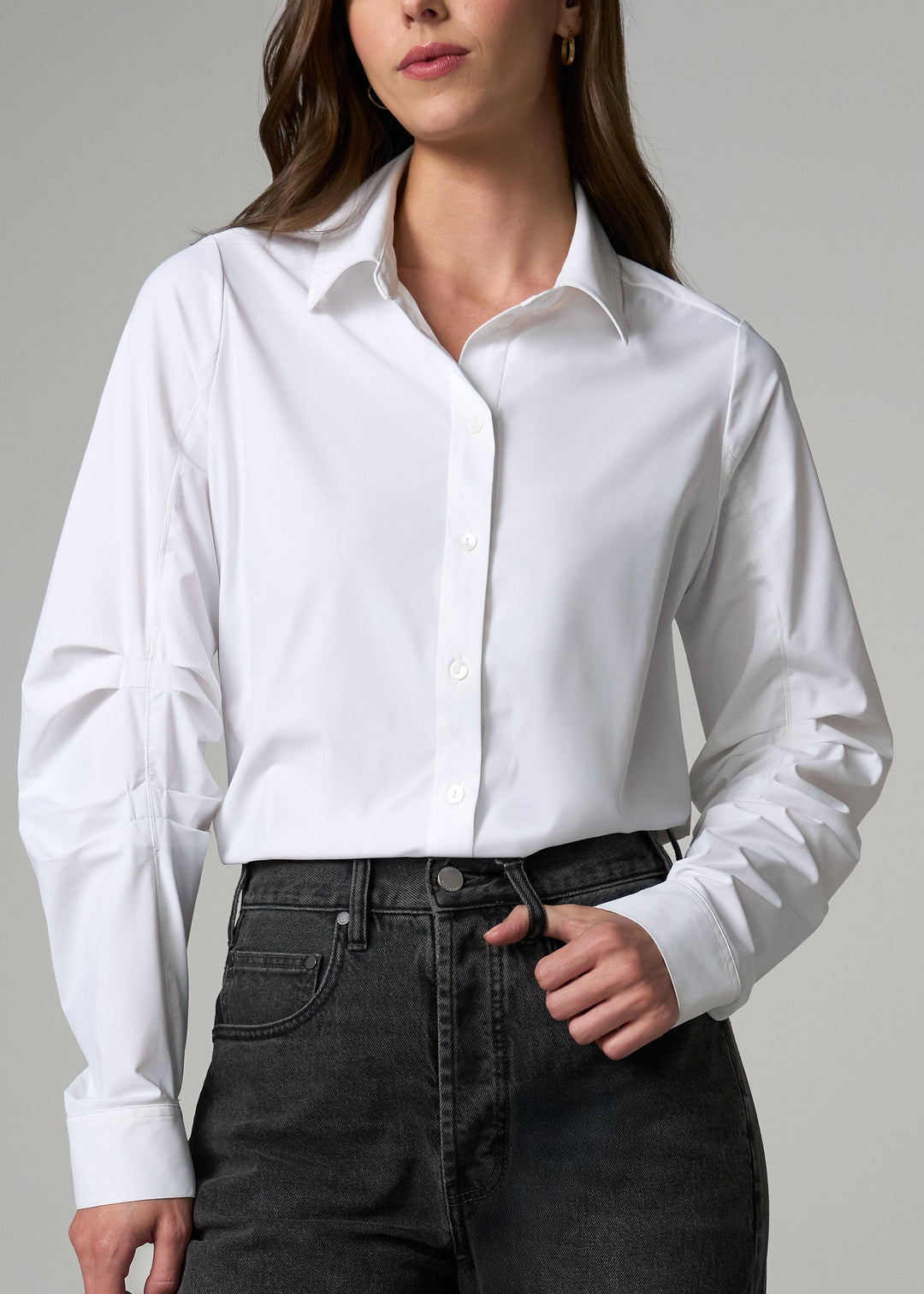 White button-front shirt with pointed collar and long pleated sleeves