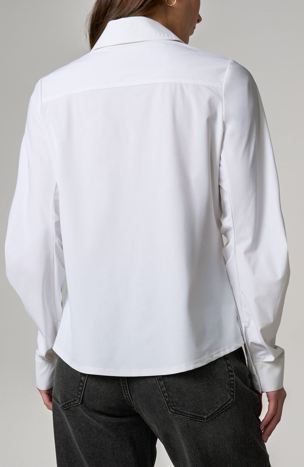 White button-front shirt, back view, long pleated sleeves and collar