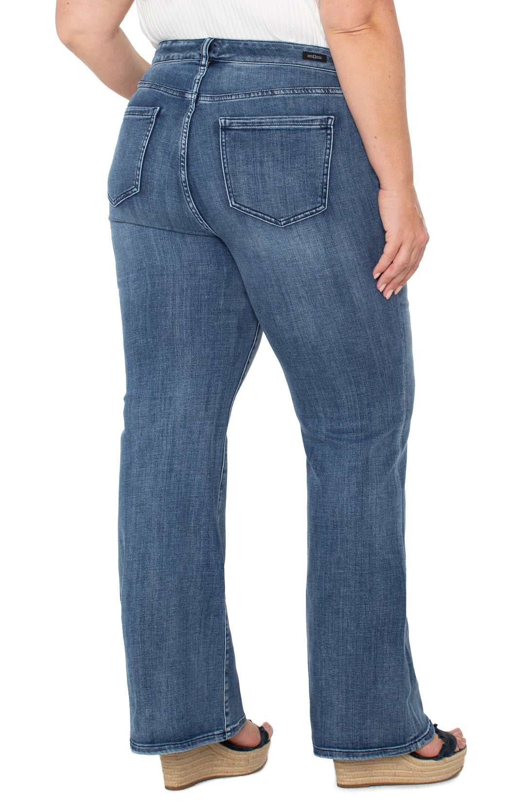 Liverpool Hannah flare jeans in medium blue denim, showing two back pockets and flared hems.