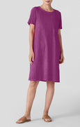 Woman wearing a purple dress on a white background