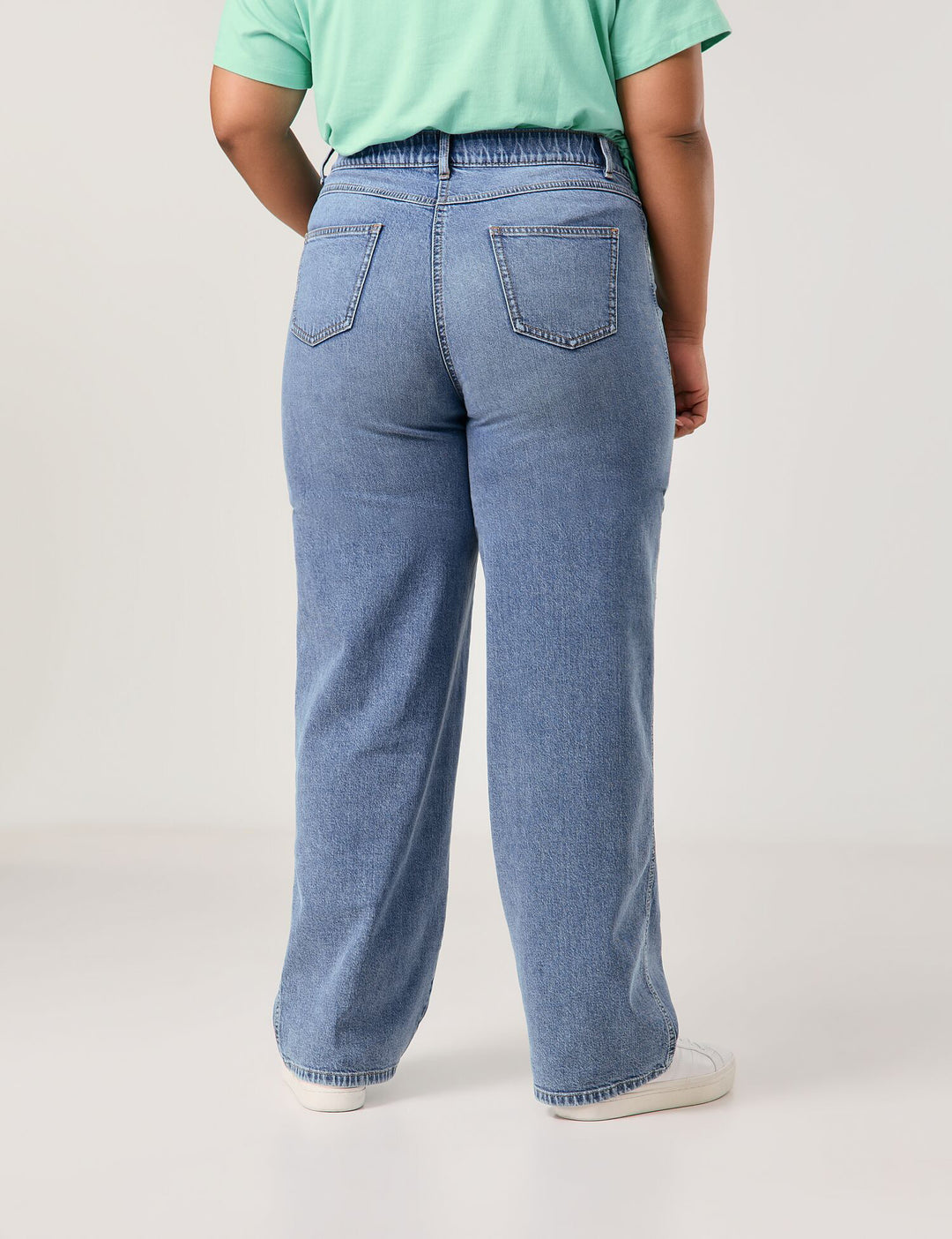 back view of plus size Samoon Carlotta Wide Leg Trouser Jean in Bleached Blue Denim on model