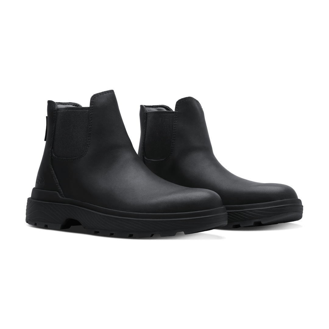 Pair of black Chelsea boots with side elastic gore and chunky rubber outsoles