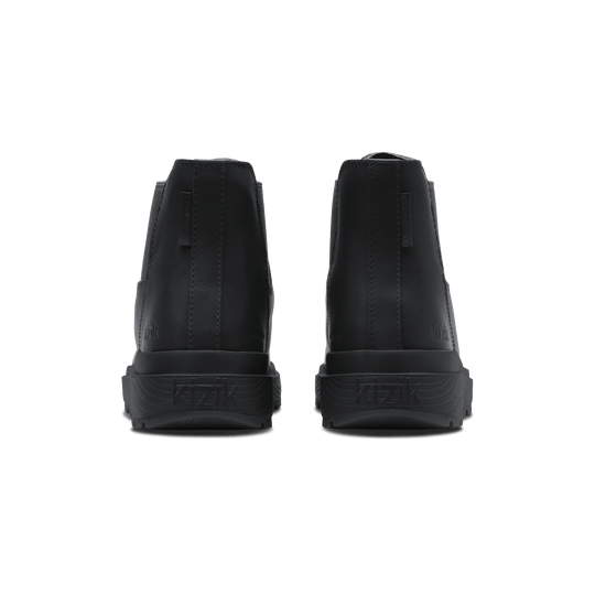 Black Chelsea boots from heel view with textured sole and back stitching detail