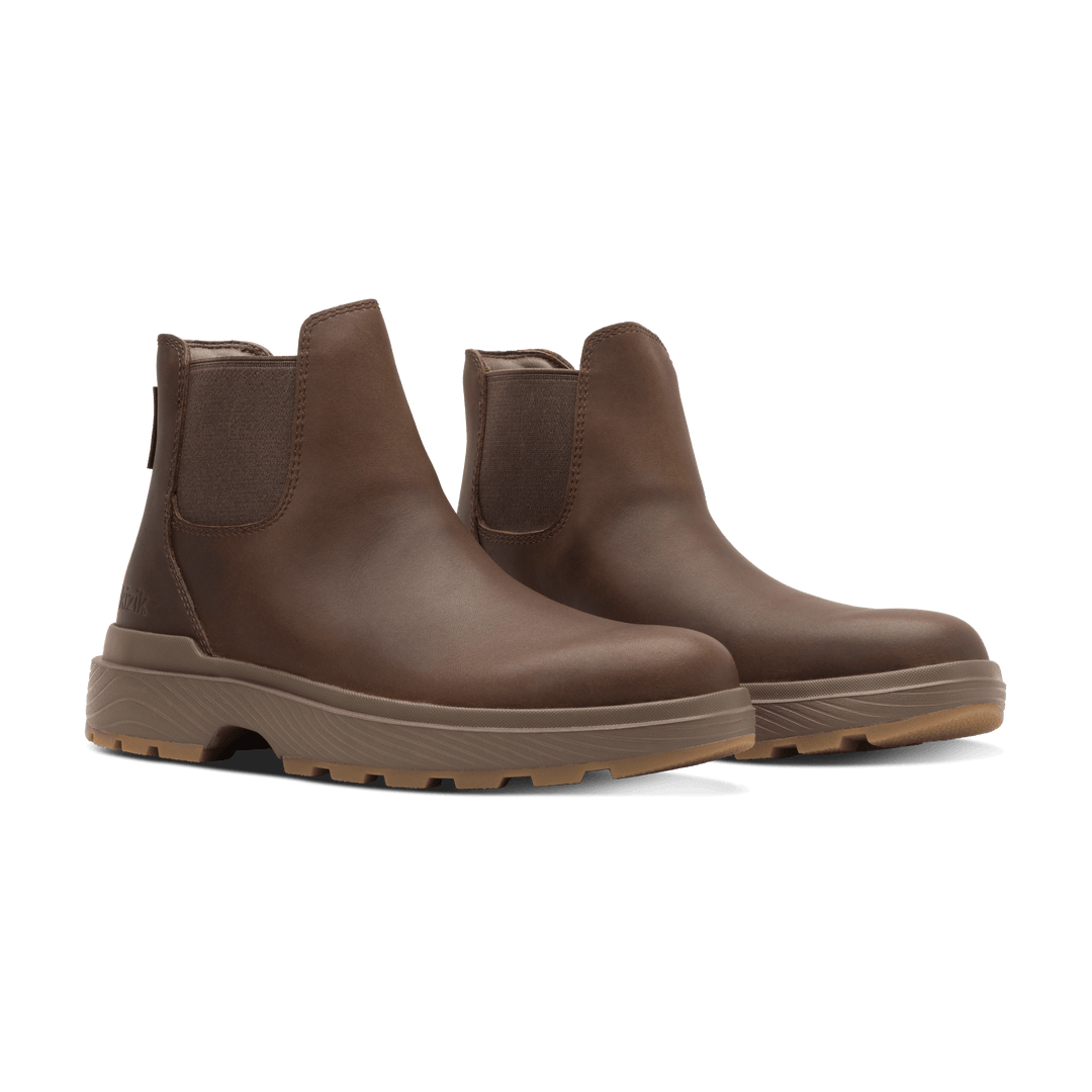 Pair of dark brown Kizik Sierra Chelsea boots with elastic gore and textured outsole.