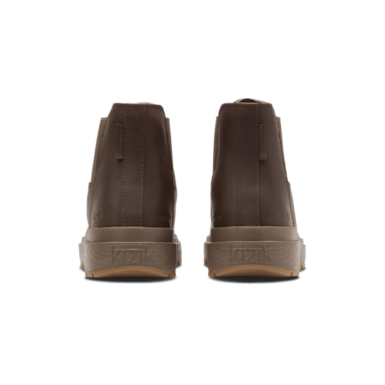 Back view of dark brown Kizik Sierra Chelsea boots with cushioned heel and branding tab.